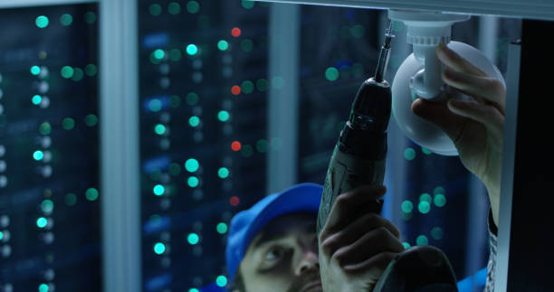 Hardened perimeter security installation with IP cameras, access control reader, and network switch at a facility entrance